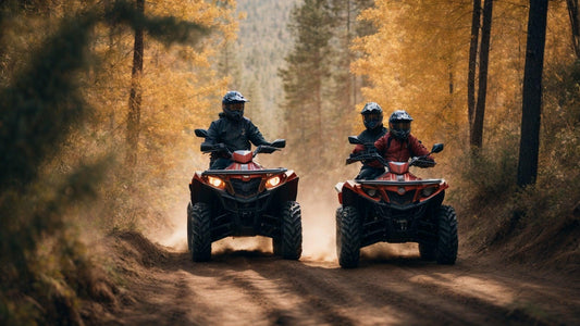 People riding red ATVs on a dirt trail through a forest with autumn foliage