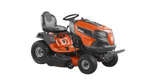 Orange riding lawn mower with large wheels and comfortable seat on white background