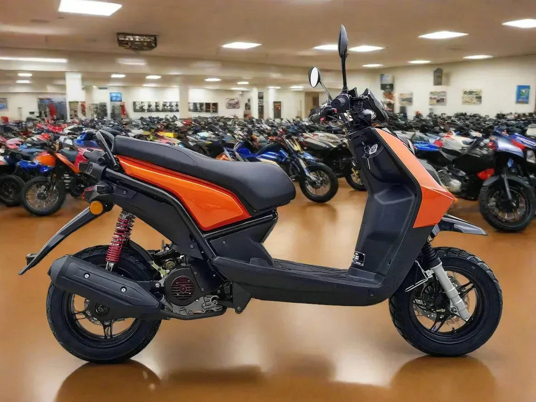 Orange and black scooter with rear suspension displayed in a showroom with motorcycles