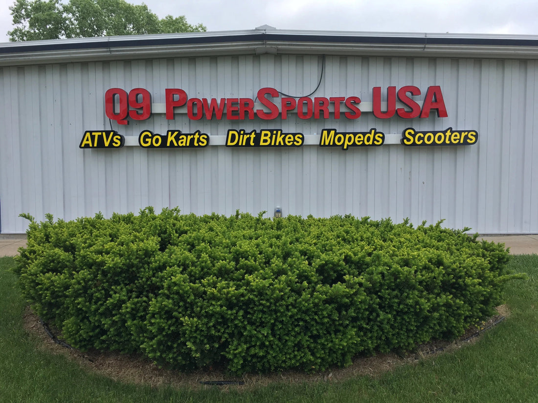 PowerSports storefront showing ATVs, go karts, dirt bikes, mopeds, scooters sign above bushes.