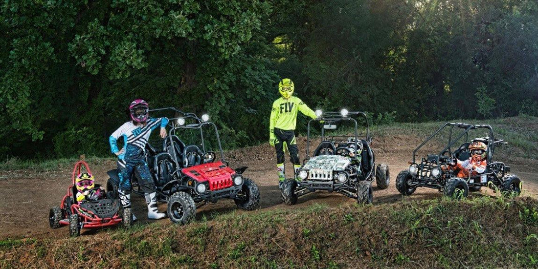 Kids and adults in helmets with go-karts and ATVs on a dirt track outdoors