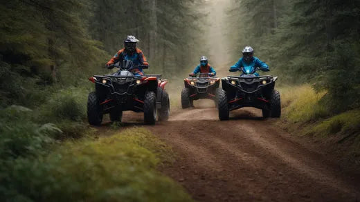 Three riders on ATVs driving on a dirt trail through a forest
