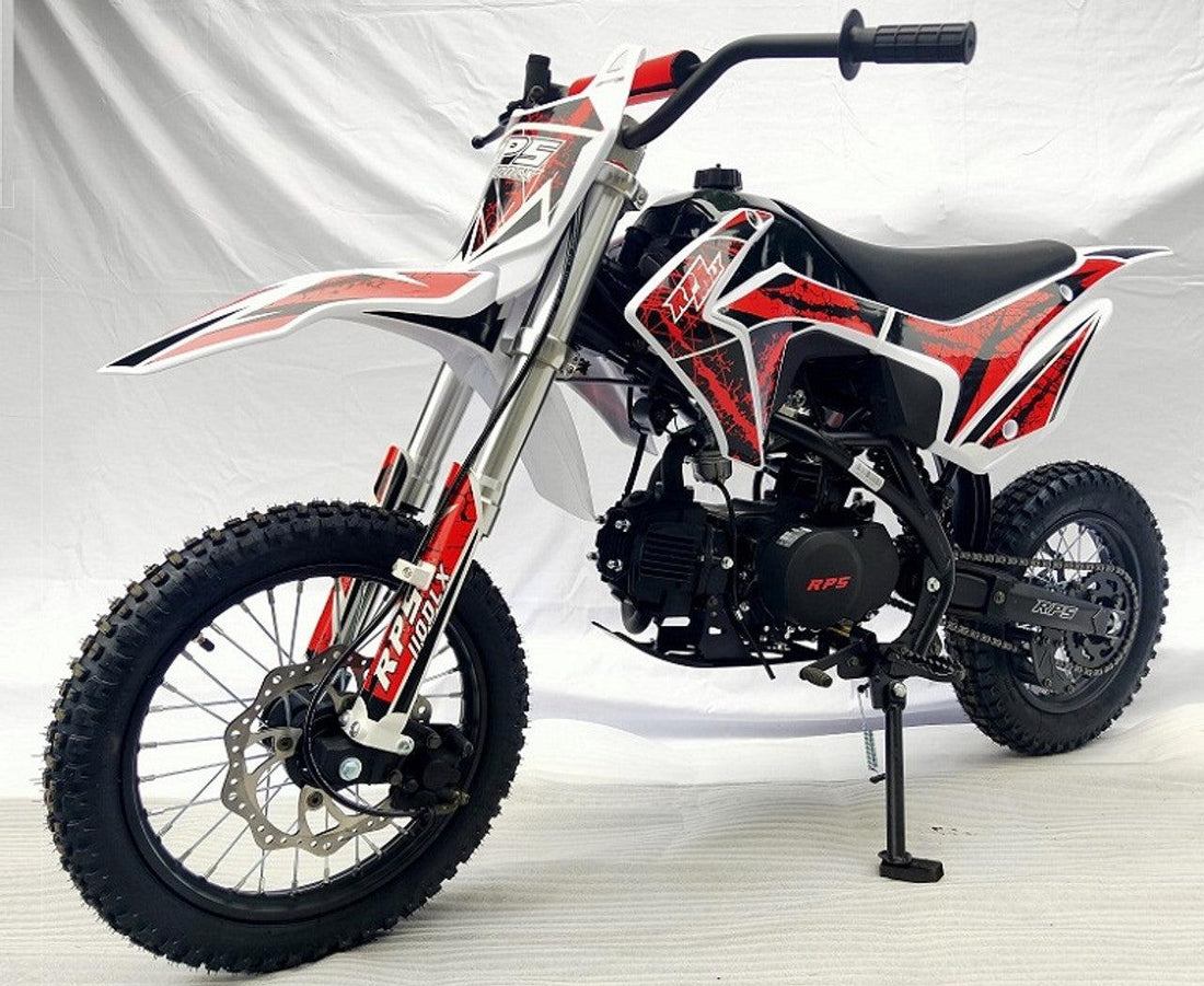 Red and black RPS dirt bike with knobby tires, side view on white background