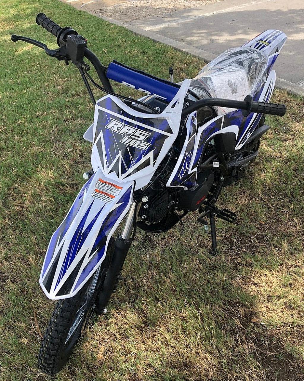 Blue and white RPS 110cc dirt bike parked on grass, off-road motorcycle for beginners