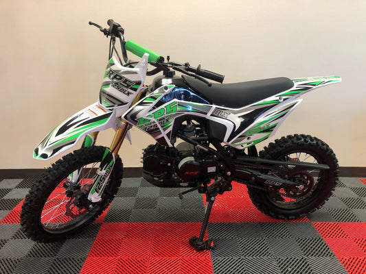 Green and white RPS dirt bike with knobby tires on showroom floor