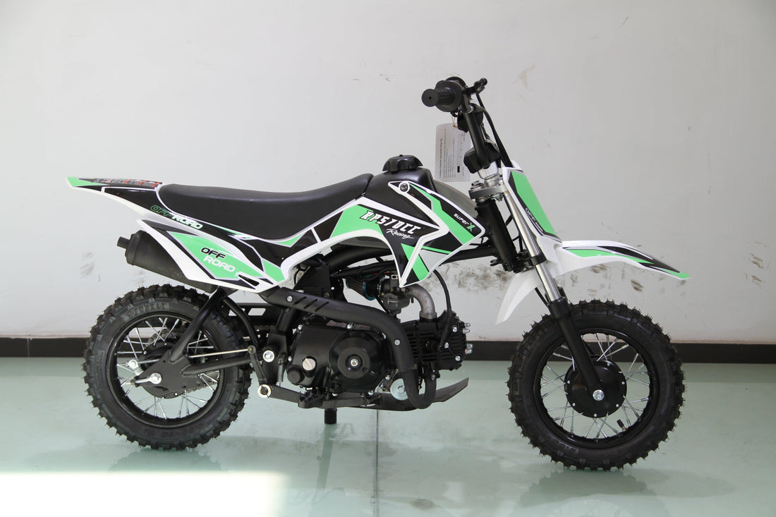 Youth dirt bike with knobby tires, green and black graphics, off-road mini motorcycle