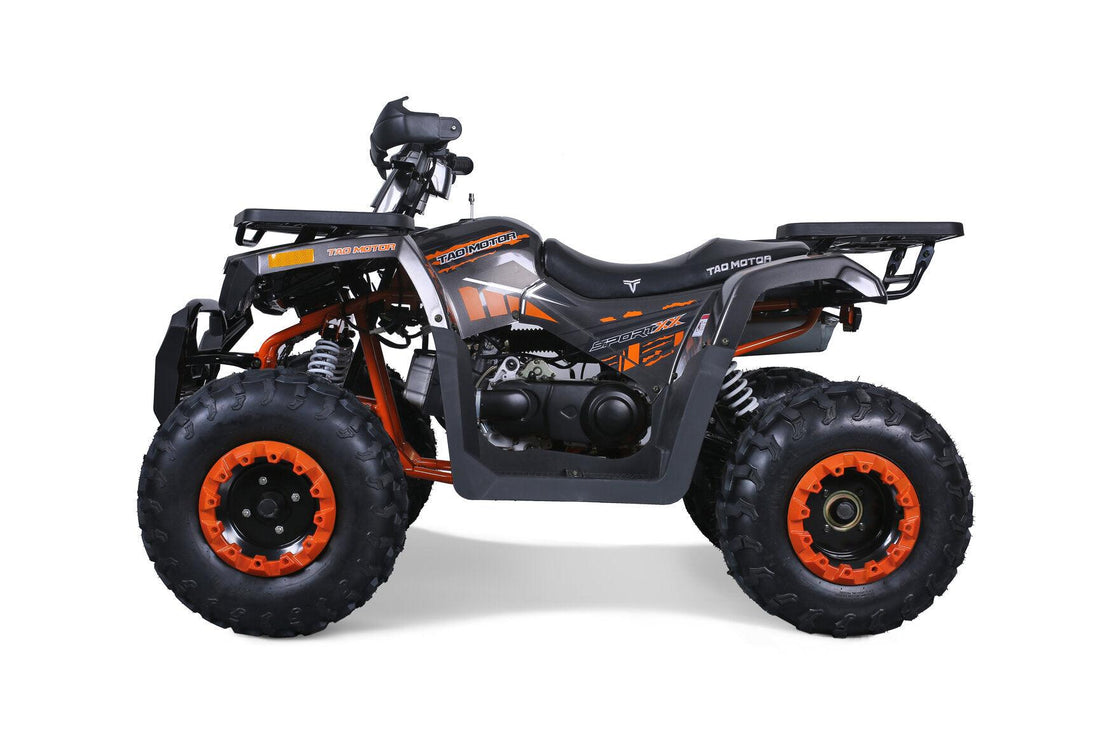 Orange and black off-road ATV with rugged tires, side profile, on white background.