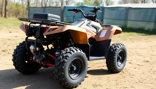 Orange ATV with rugged tires parked outdoors on dirt, ideal for off-road riding