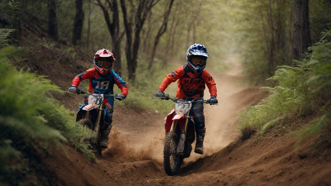 Two kids riding youth dirt bikes on a forest trail wearing helmets and motocross gear