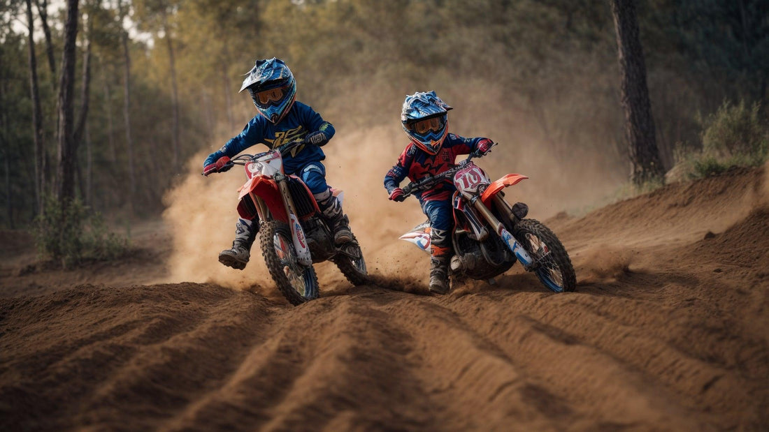 Two kids riding dirt bikes on a sandy motocross trail outdoors, wearing helmets and gear