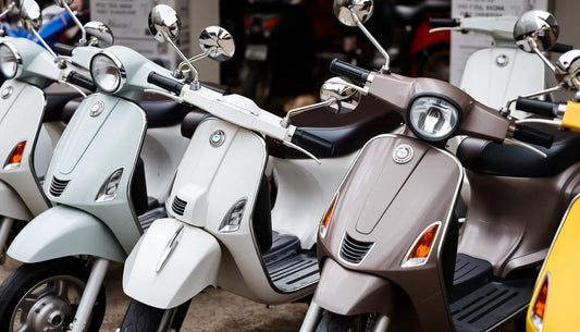 Row of modern scooters in various colors parked outdoors, showcasing sleek scooter design.