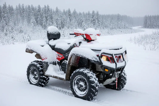 ATV covered in snow parked outdoors on a snowy trail with winter forest background