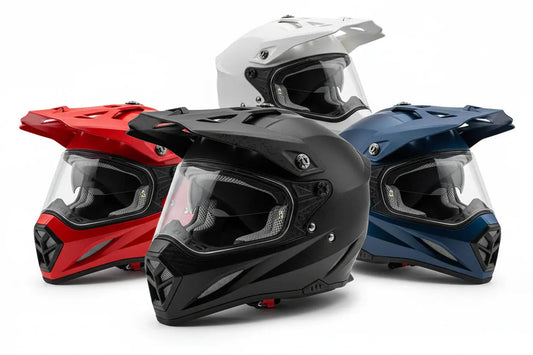 Assorted ATV helmets in black, red, blue, and white colors with visors and vents.