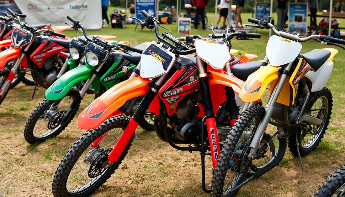 Colorful off-road dirt bikes lined up outdoors on a grassy field for display