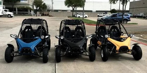 Three youth go-karts in blue, black, and yellow parked outside Q9 PowerSports USA dealership