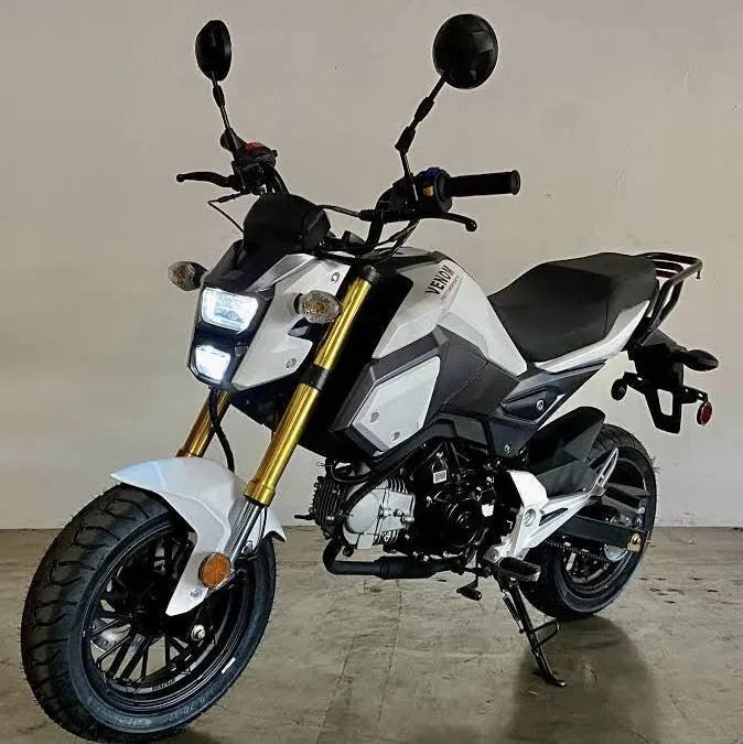 White mini street bike motorcycle with LED lights and black accents on an indoor concrete floor