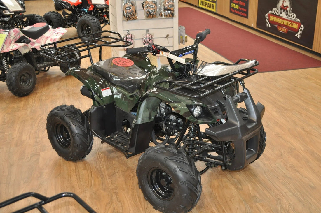 Green camo ATV with front and rear racks on showroom floor, off-road tires visible