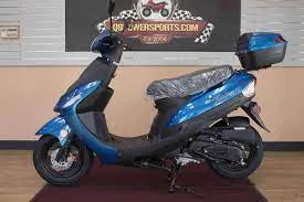 Blue adult scooter with rear storage box displayed indoors on showroom floor