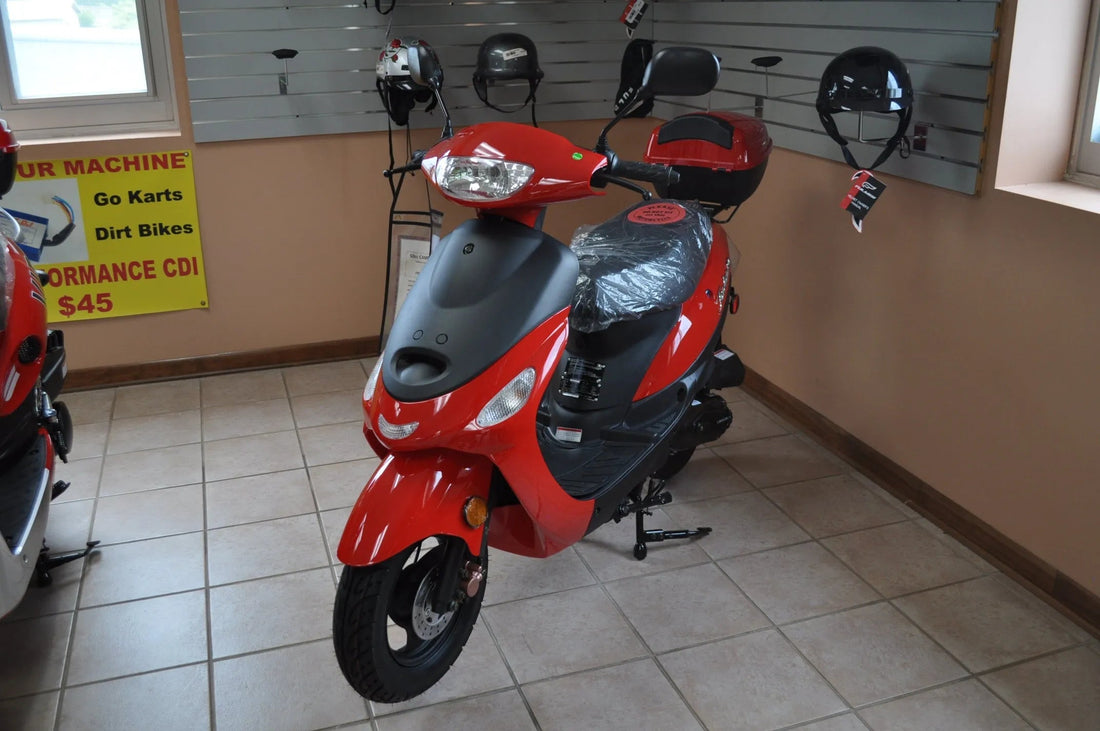 Red motor scooter on showroom floor with helmets displayed on wall and tiled flooring