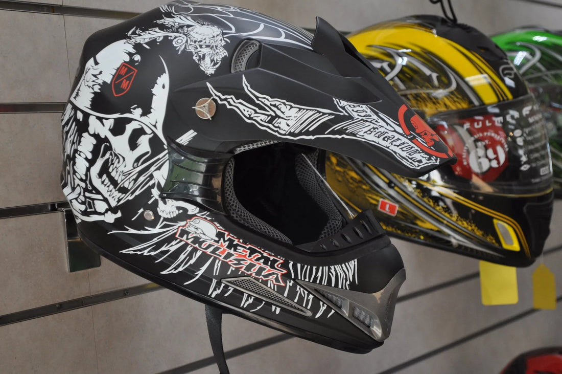 Black motocross helmet with skull graphics on display, off-road ATV dirt bike safety gear