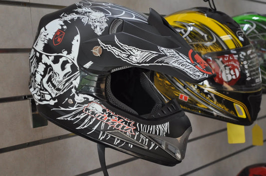Black motocross helmet with skull graphics on display, off-road ATV dirt bike safety gear