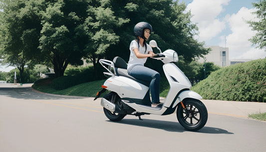 Woman riding a white scooter on a sunny street with trees and greenery in the background