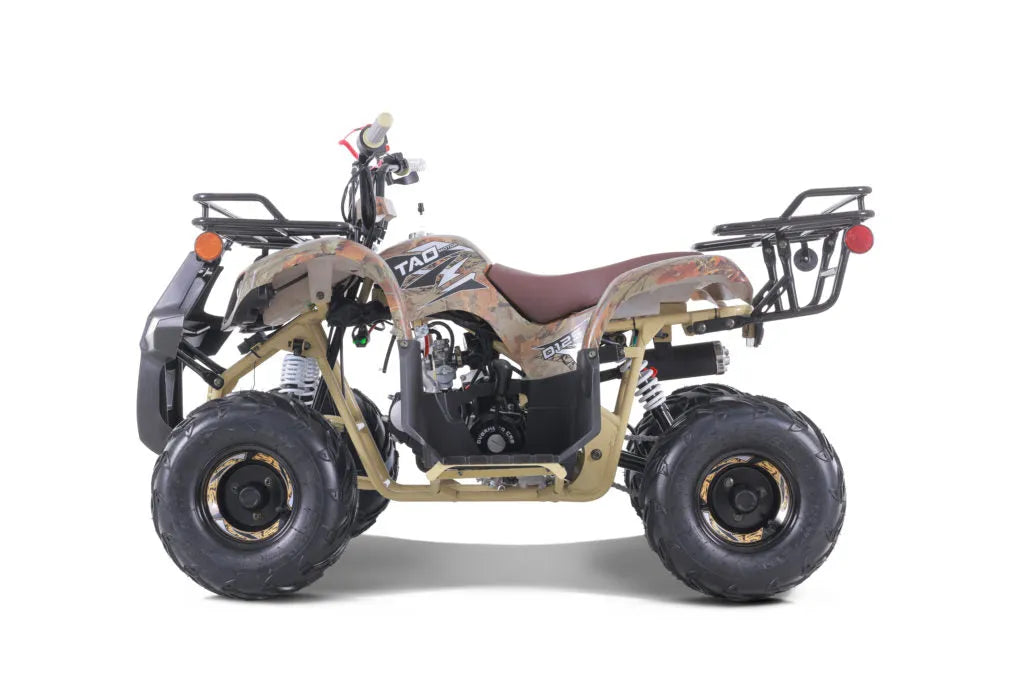 Youth camouflage ATV with rugged tires, rear cargo racks, and off-road features