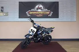 Youth dirt bike with number 10 on display indoors, ideal for beginners and off-road riding.