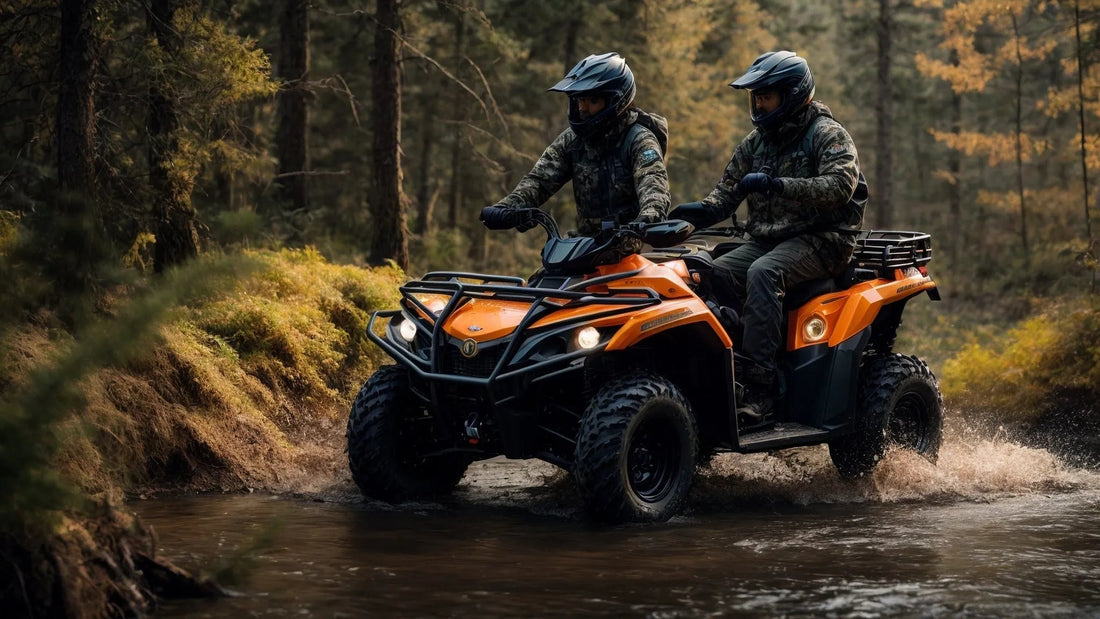 Two riders on an orange ATV driving through a forest stream, wearing helmets and gear.