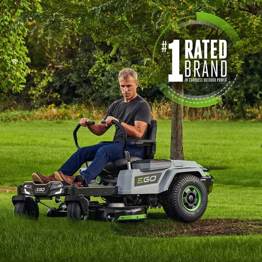 Man riding EGO zero turn cordless electric lawn mower on green grass outdoors