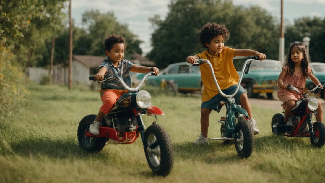 Kids riding mini dirt bikes and bikes on grass outdoors, vintage cars in background