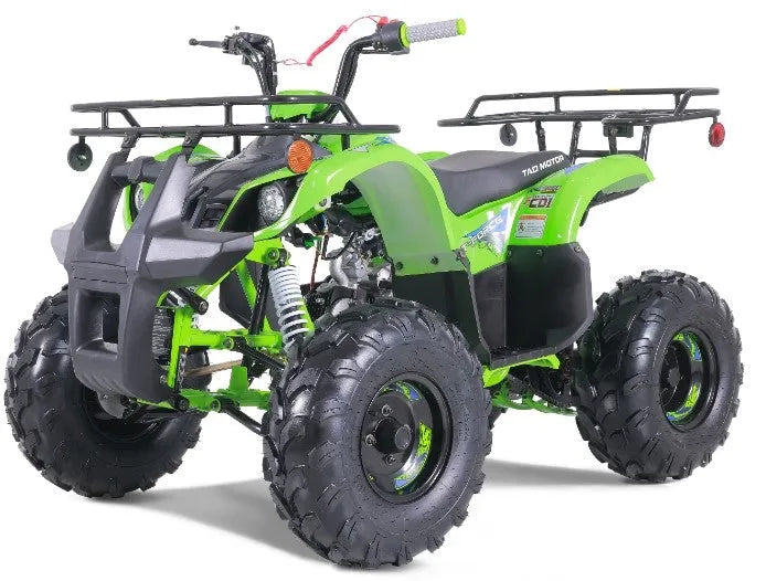 Green youth ATV with rugged tires and front and rear racks on white background