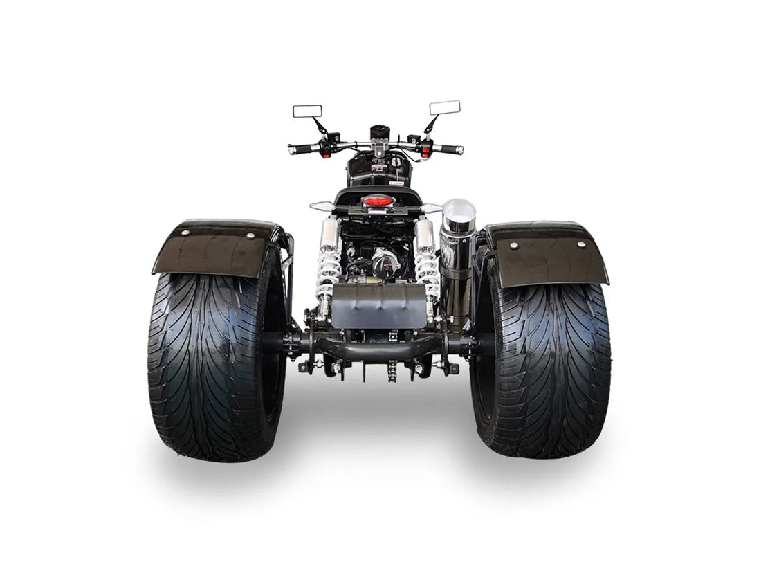 Rear view of black all-terrain ATV with wide tires and dual shock absorbers on white background