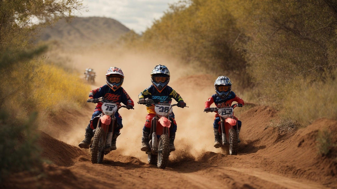 Three kids riding red youth dirt bikes on a dirt trail, wearing helmets and safety gear, Q9 PowerSports USA