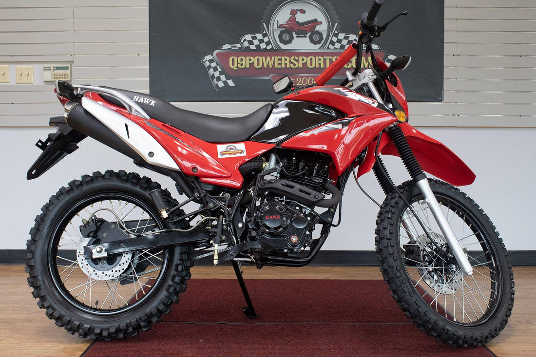 Red 250cc enduro dirt bike with knobby tires and off-road suspension on showroom floor