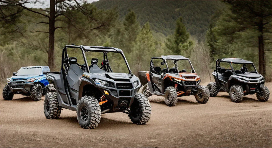 Four off-road ATVs with rugged tires driving on a dirt trail in a wooded outdoor setting.