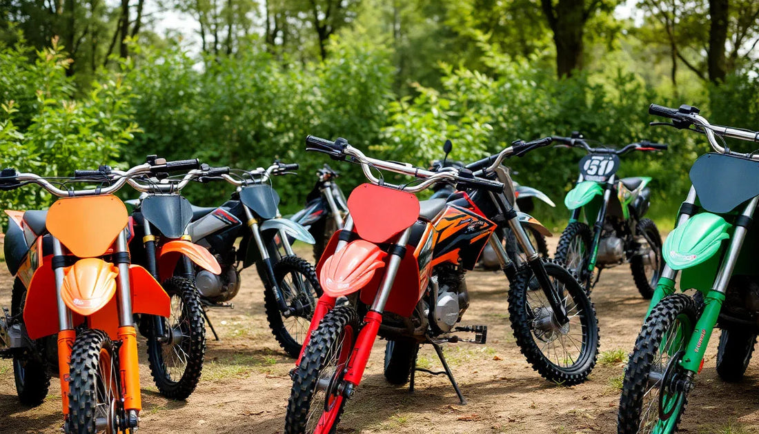Off-road dirt bikes with knobby tires parked outdoors on a dirt path in a wooded area