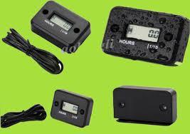 Digital hour meter for ATVs and dirt bikes, black casing with cables, on green background