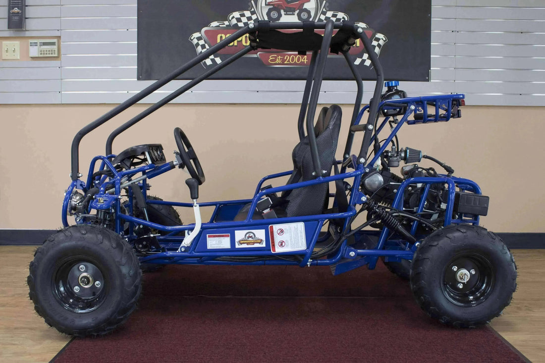 Blue double seat 110cc kids go-kart with roll cage, off-road tires, and bucket seats indoors