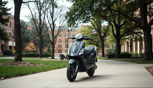 Black scooter parked on a campus sidewalk surrounded by trees and brick buildings