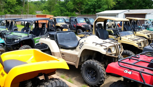 Outdoor lot with multiple ATVs and utility vehicles in various colors, ready for off-road use