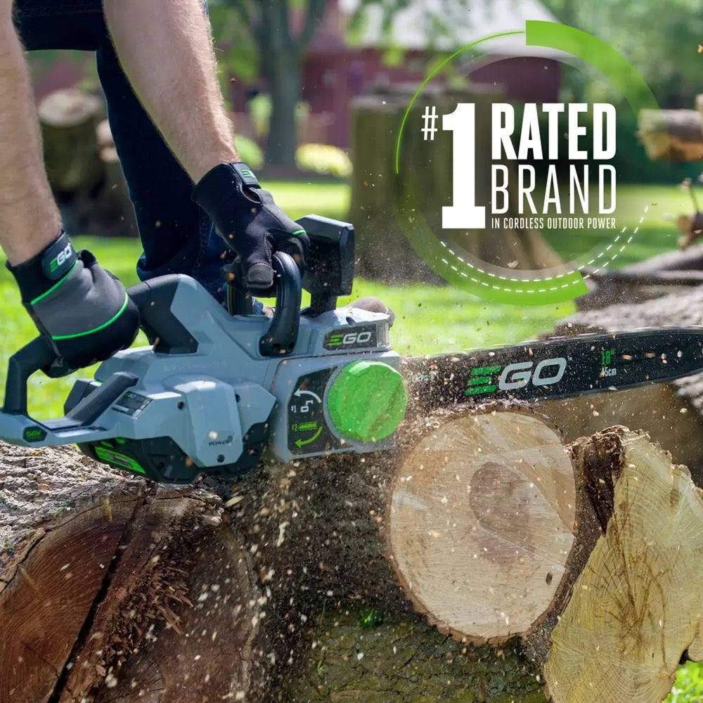 Battery-powered EGO 18-inch chainsaw cutting log outdoors, wood chips flying, cordless tool