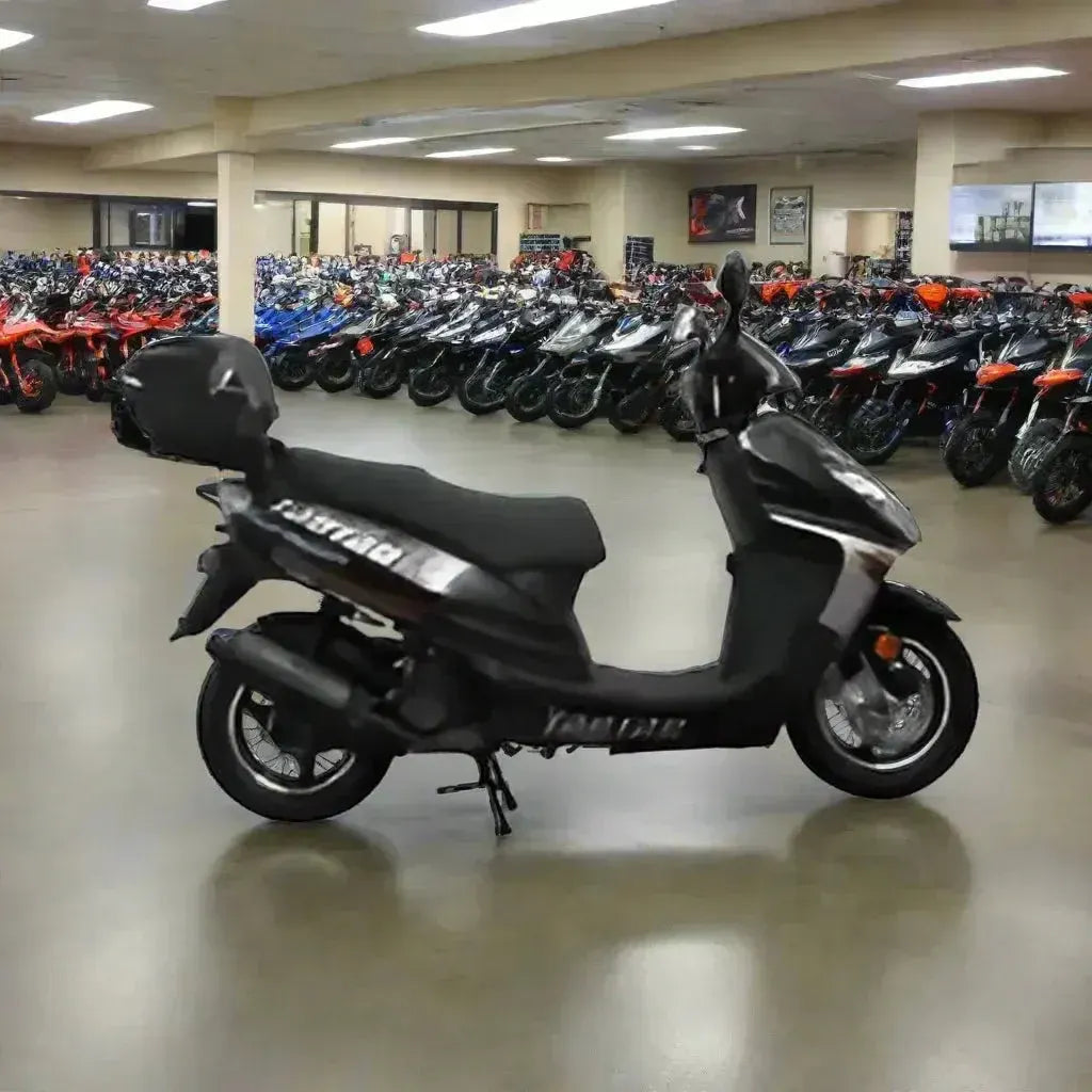 Black motor scooter on showroom floor with rows of ATVs and scooters in background