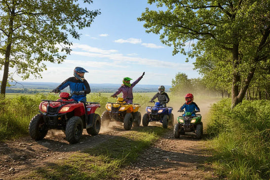 Family of four riding ATVs on a dirt trail through forested countryside on a sunny day