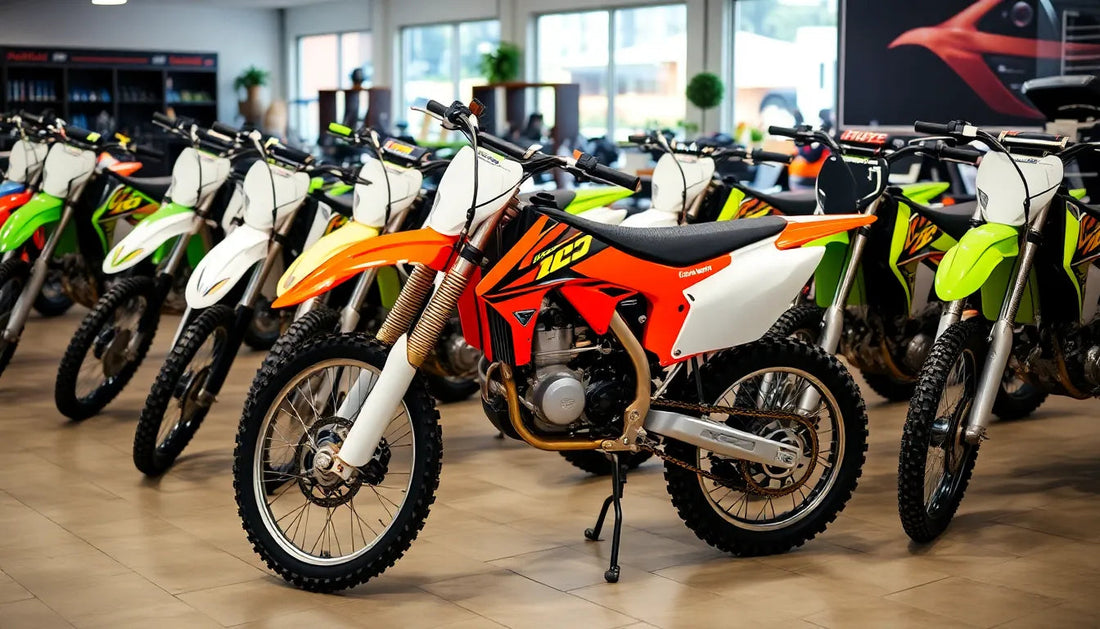 Colorful dirt bikes lined up in a showroom with bright lighting and tile flooring.
