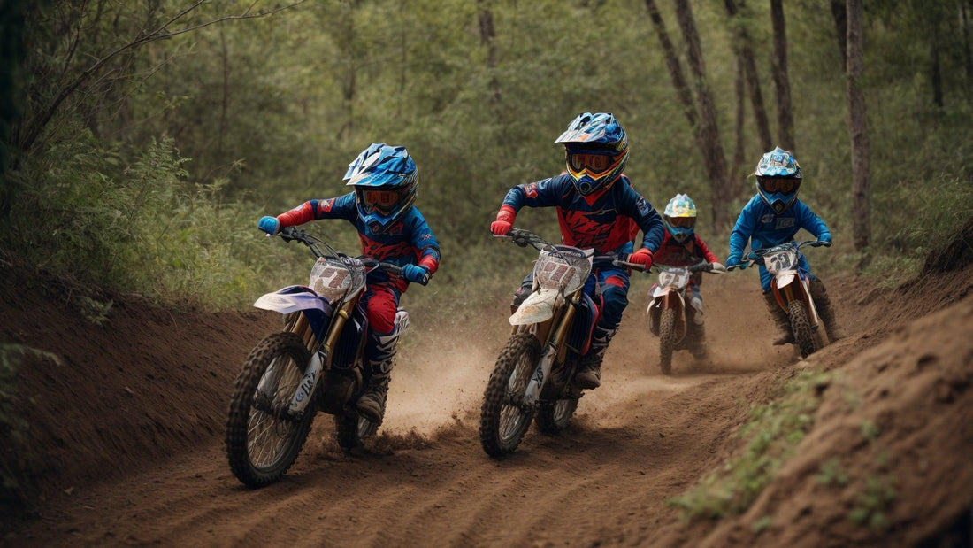 Kids riding gas-powered youth dirt bikes on a forest trail in full motocross gear