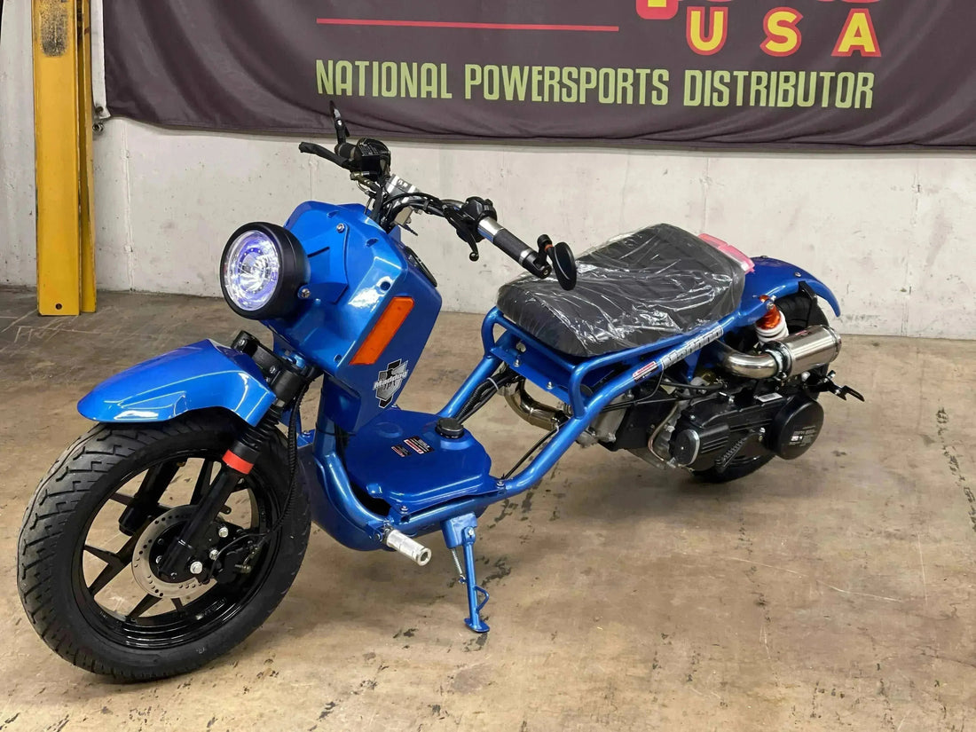 Blue 150cc scooter with exposed frame and headlight parked indoors on concrete floor