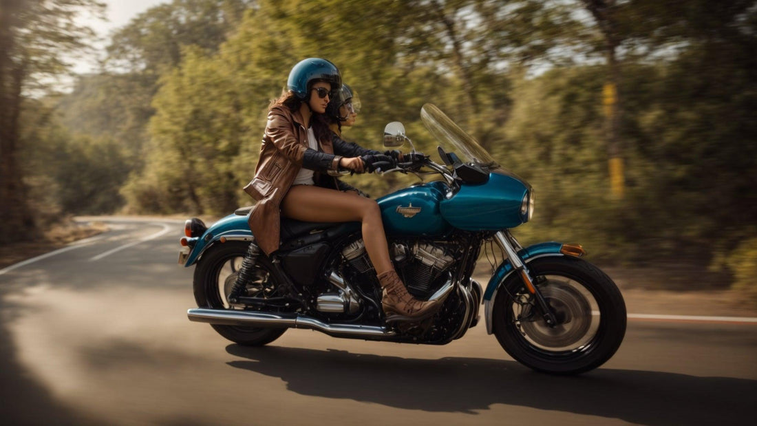 Two riders wearing helmets on a blue touring motorcycle riding on a scenic road