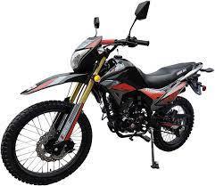 Black and red dirt bike motorcycle with rugged tires and street-legal features on white background.