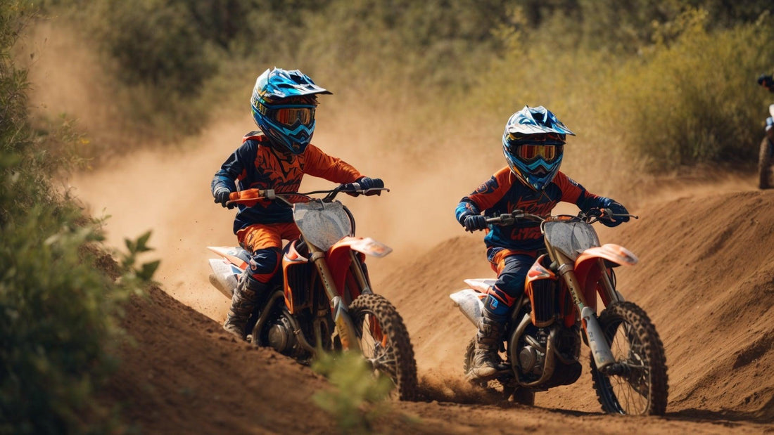 Kids riding orange dirt bikes on a dirt trail, wearing helmets and motocross gear